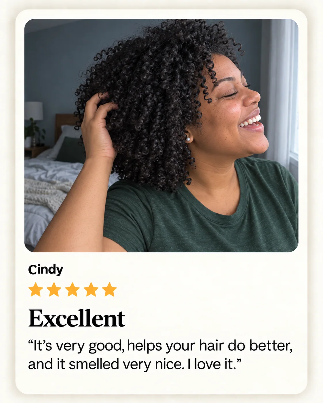 Illustrative photo of a woman facing right and laughing with her eyes closed as she lifts her curls by a bedroom window